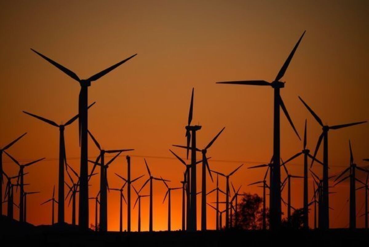 Giant turbines are powered by strong winds during sunset in Palm Springs last month. California installed enough new turbines in 2012 to climb to second place in the U.S. in wind power generation.