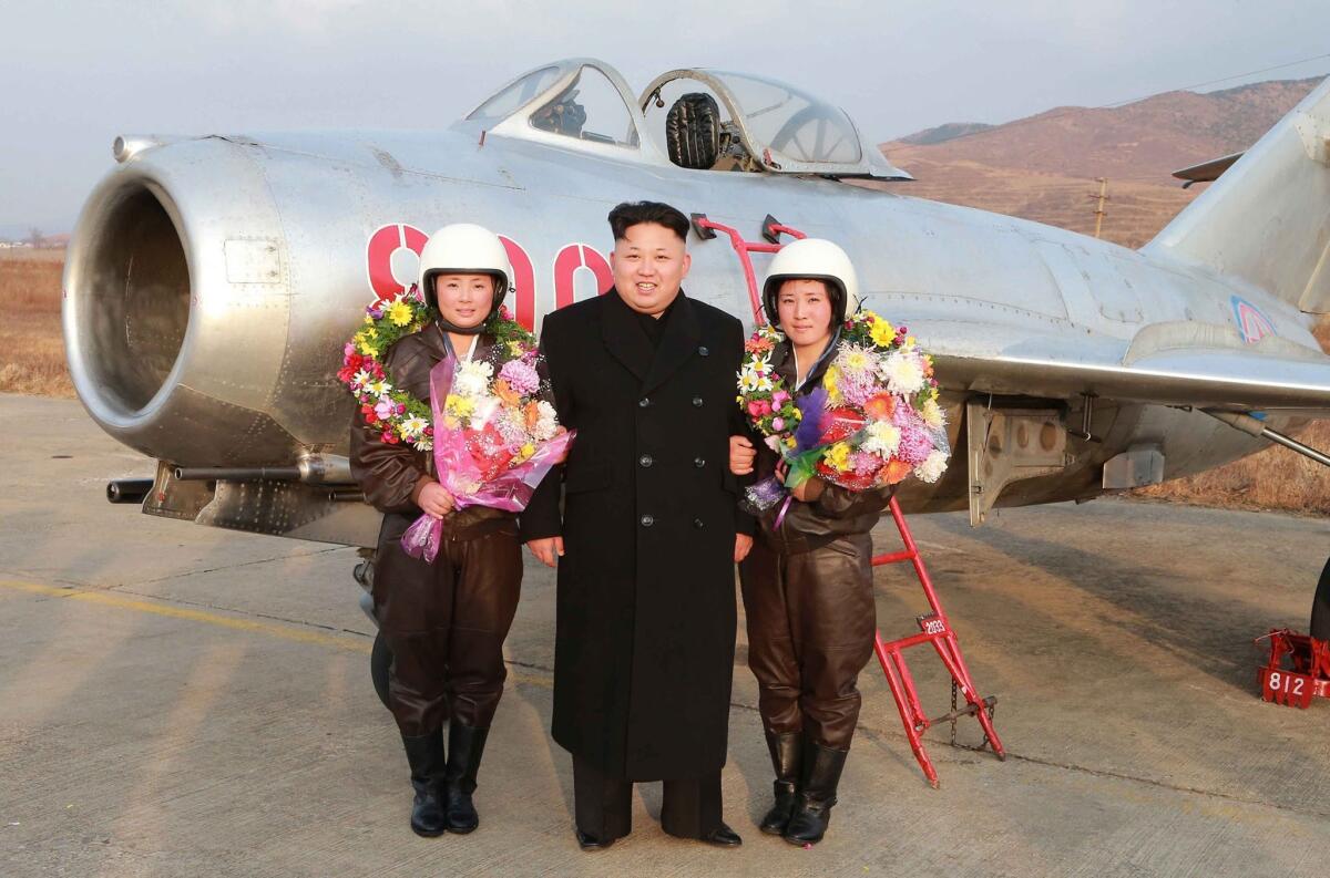 North Korean leader Kim Jong Un is flanked by airwomen of the KPA Air Force at an undisclosed base on Nov. 28. Pyongyang has reportedly banned other North Koreans from sharing his name.