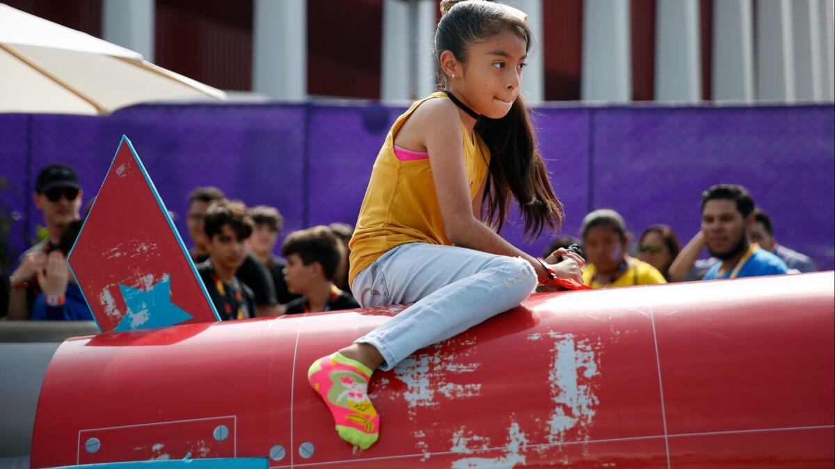 Hayllee Galaviz, 9, rides a rocket at the Fortnite Summer Block Party.