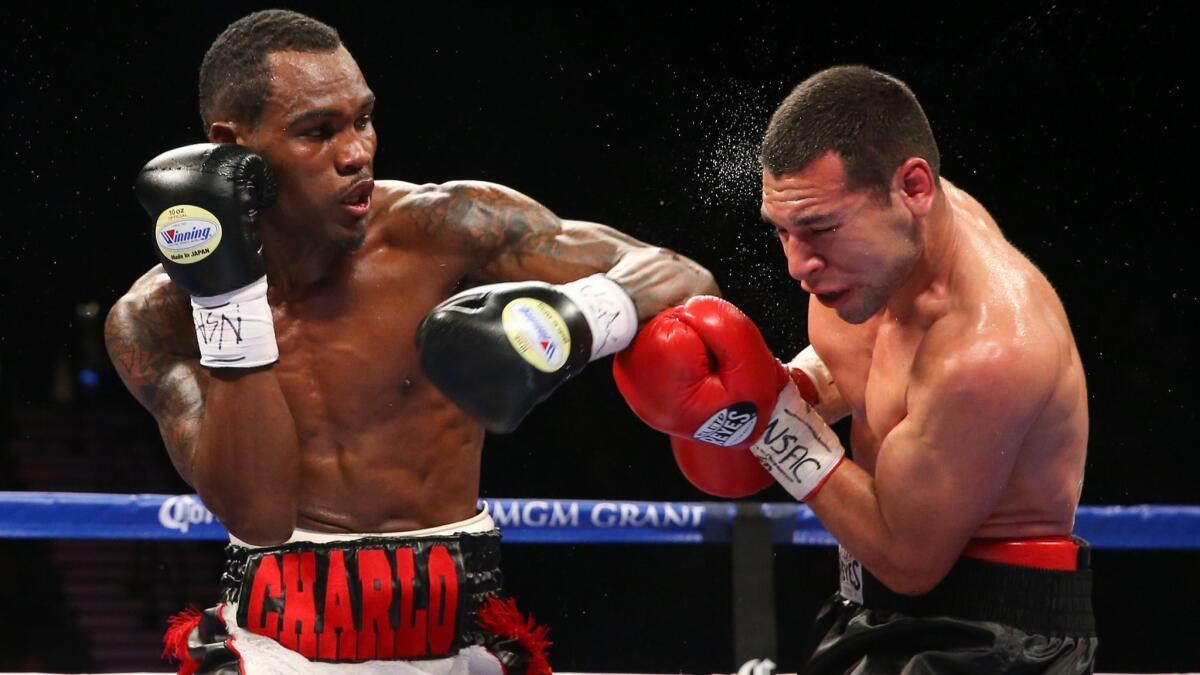 Jermell Charlo, left, lands a punch to the head of Mario Lozano on Dec. 13, 2014, in Las Vegas.