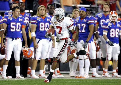 Ohio State's Ted Ginn Jr. runs past the Florida bench as he returns the opening kick off for a 93-yard touchdown in the first BCS national championship football game at University of Phoenix Stadium in Glendale, Ariz.