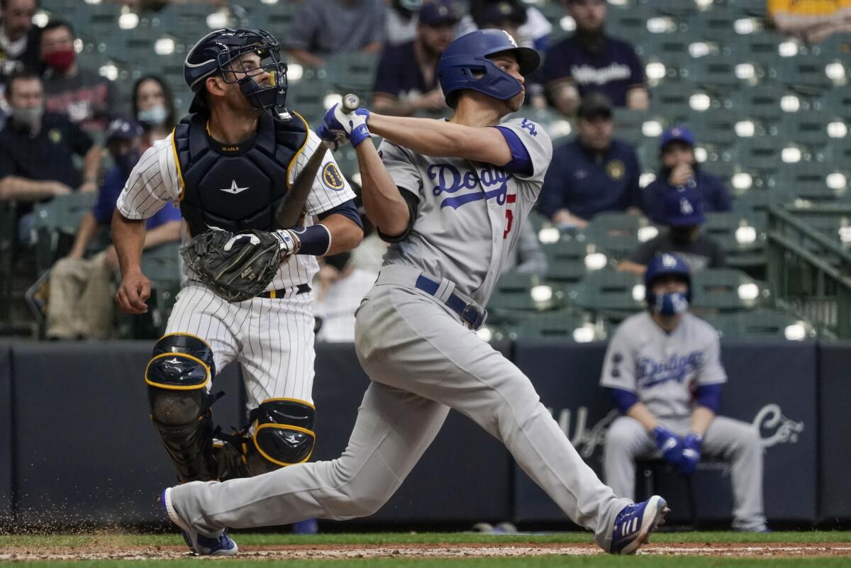 Dodgers shortstop Corey Seager hits an run-scoring triple in the third inning.