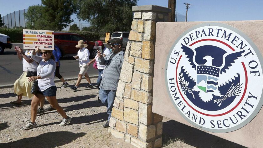 Protesters walk outside the El Paso Processing Center in June. Federal officials are force-feeding some of the immigrants who have been on hunger strike for nearly a month inside the Texas detention facility.