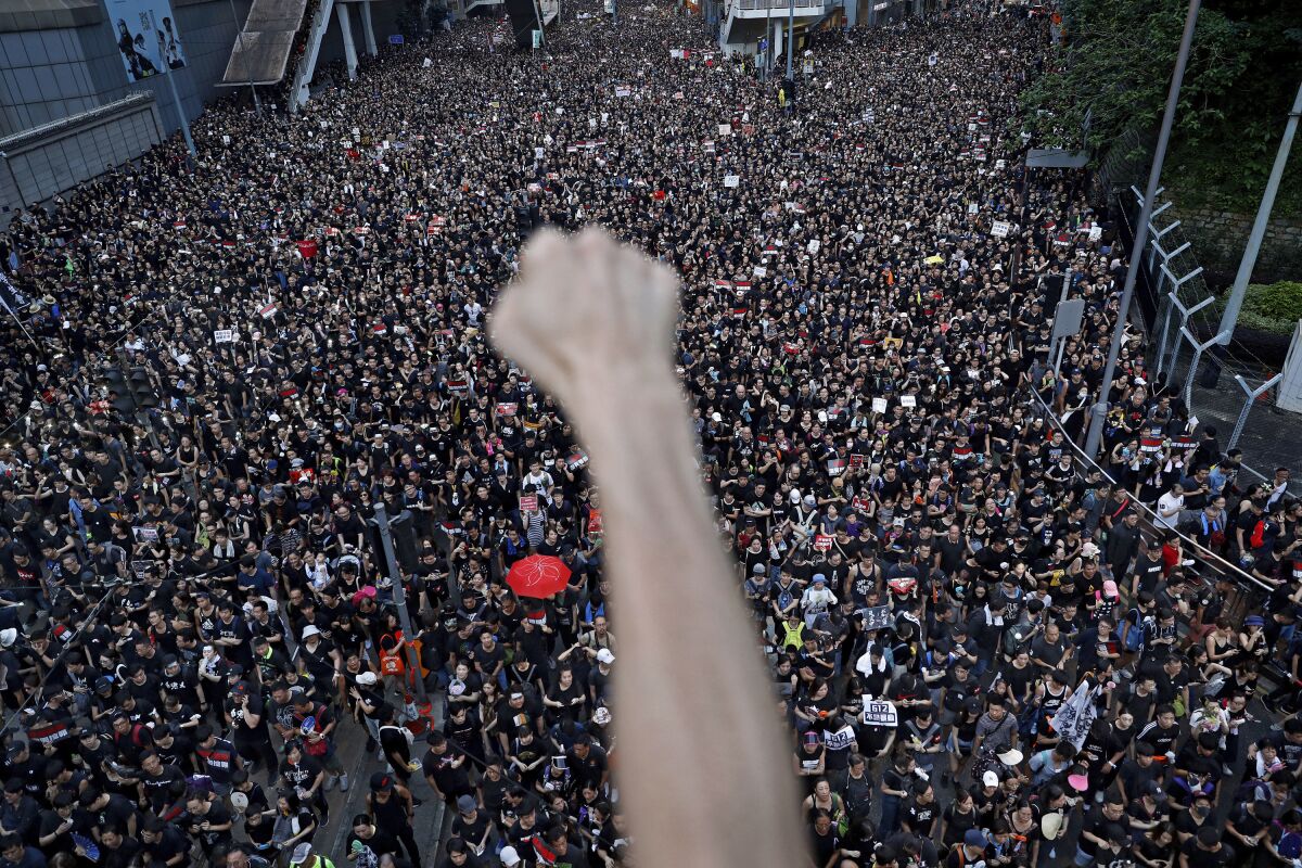 FILE - In this June 16, 2019, file photo, protesters march on the streets against an extradition bill organized by Civil Human Right Front in Hong Kong. Pro-democracy group, Civil Human Rights Front that organized some of the biggest protests during the months of upheaval in Hong Kong in 2019 is dissolving, the group said Sunday, Aug. 15, 2021. (AP Photo/Vincent Yu, File)