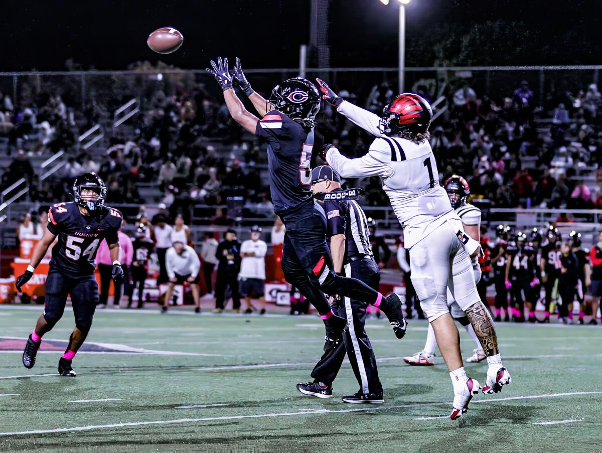 Boogie Williams of Corona Centennial comes up with an interception against Murrieta Valley.