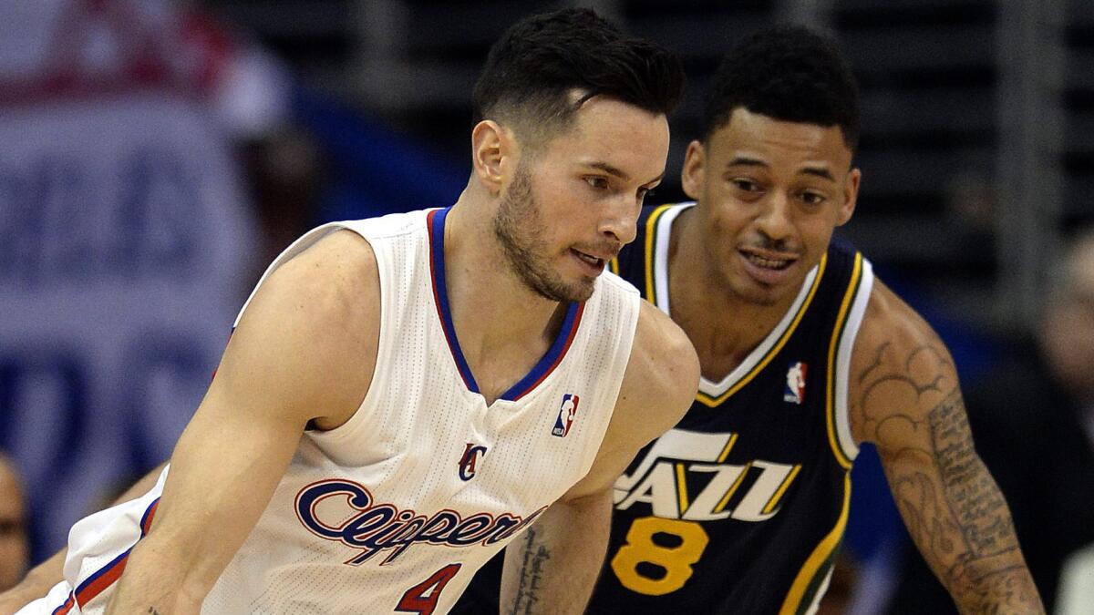 Clippers guard J.J. Redick, left, drives past Utah Jazz point guard Diante Garrett in February. Redick has moved on from last year's playoff loss to the Oklahoma City Thunder.