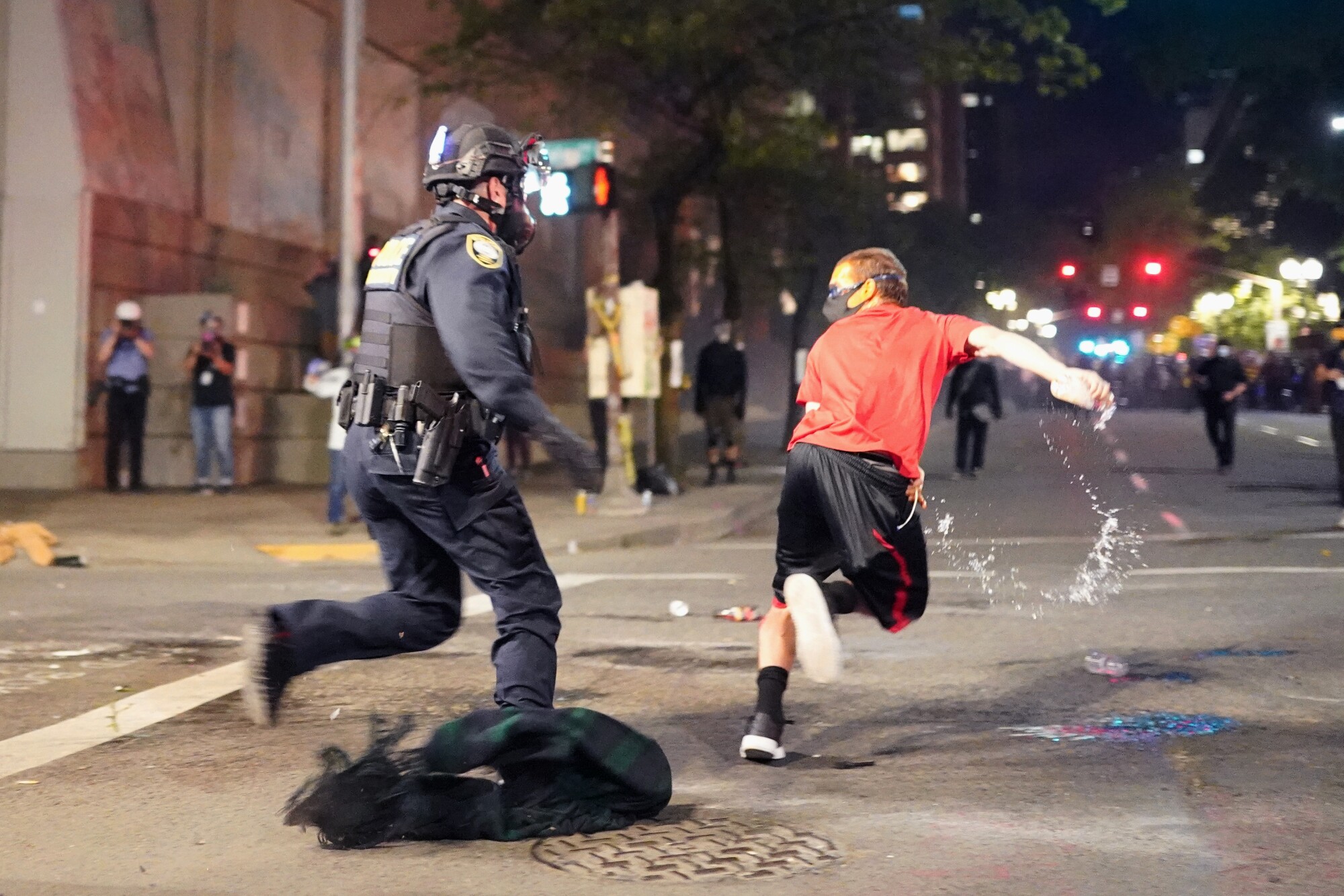 A protester escapes a federal officer during an arrest attempt in Portland, Ore.
