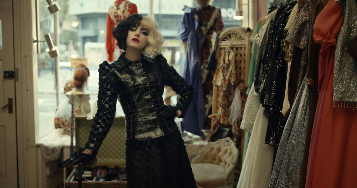 Emma Stone vamps in shiny black couture in "Cruella"