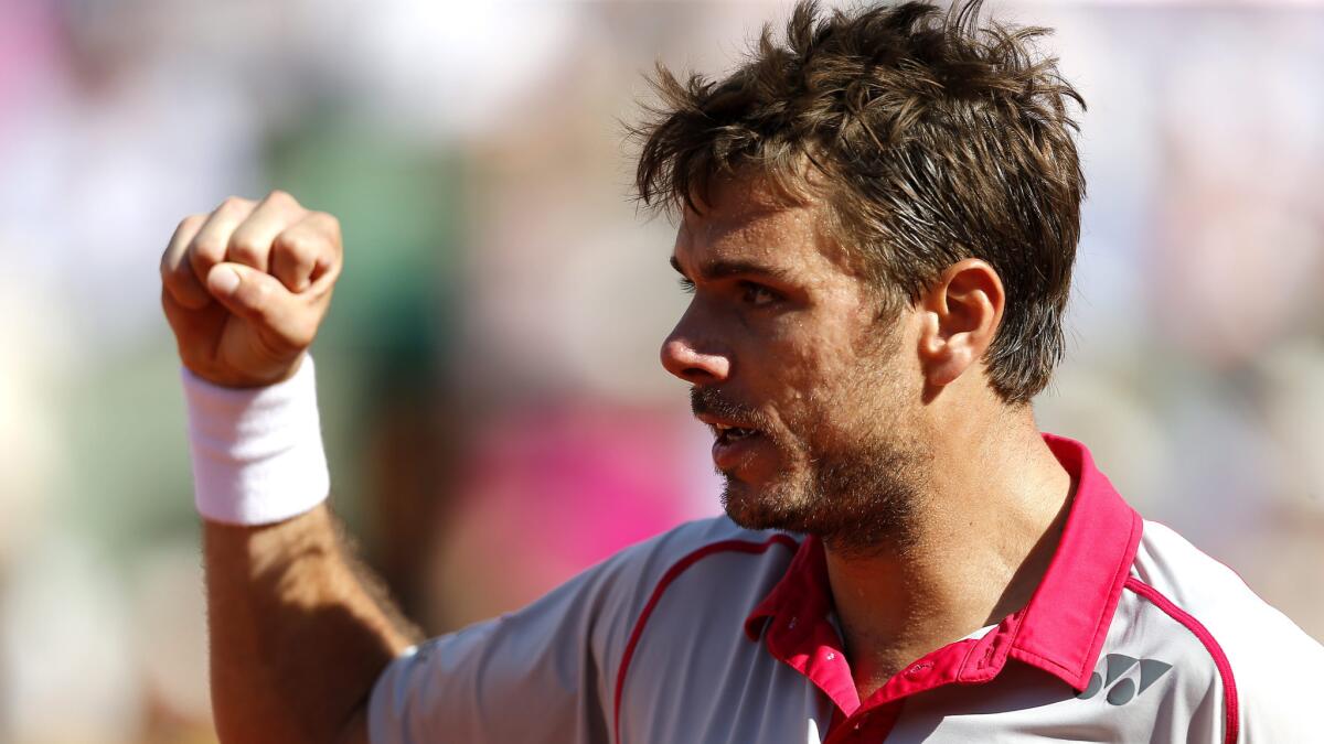 Stan Wawrinka celebrates during his victory over Novak Djokovic for the French Open singles title on June 7, 2015.