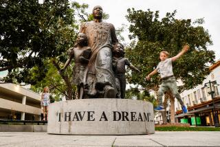 A youngster leaps off the Martin Luther King “I Have a Dream” statue