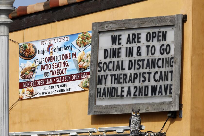 A sign at Baja Sharkeez, at the Newport Pier in Newport Beach on Wednesday, July 1, 2020.