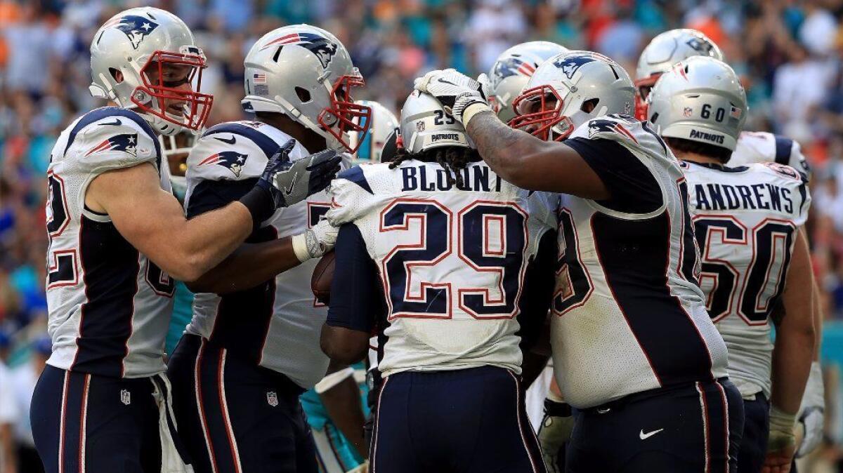 Patriots running back Legarrette Blount celebrates after scoring a touchdown against the Dolphins during a game on Jan. 1.