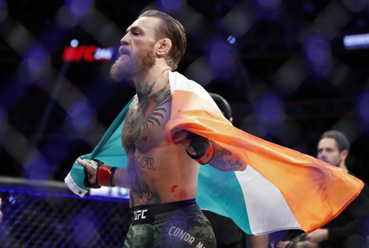 Conor McGregor celebrates after defeating Donald "Cowboy" Cerrone during a welterweight fight.