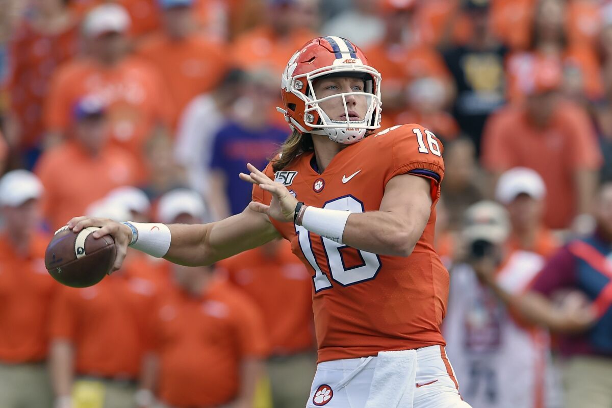 FILE - In this Oct. 12, 2019, file photo, Clemson's Trevor Lawrence throws a pass during the first half of an NCAA college football game against Florida State, in Clemson, S.C. Lawrence is a candidate for the 2020 Heisman Trophy award. (AP Photo/Richard Shiro, File)