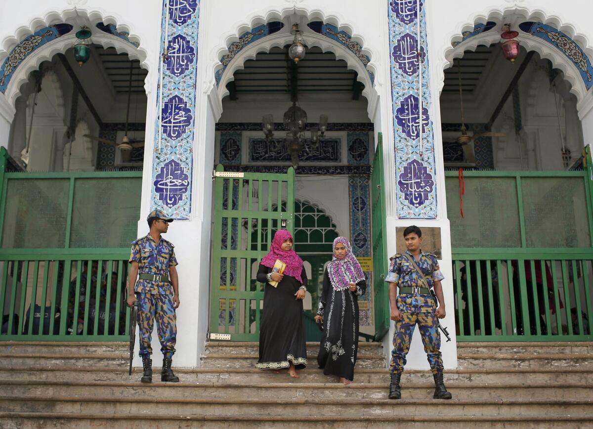 Bangladeshi security personnel stand guard at the entrance of a shrine, the site of an explosion, in Dhaka, Bangladesh, on Saturday.