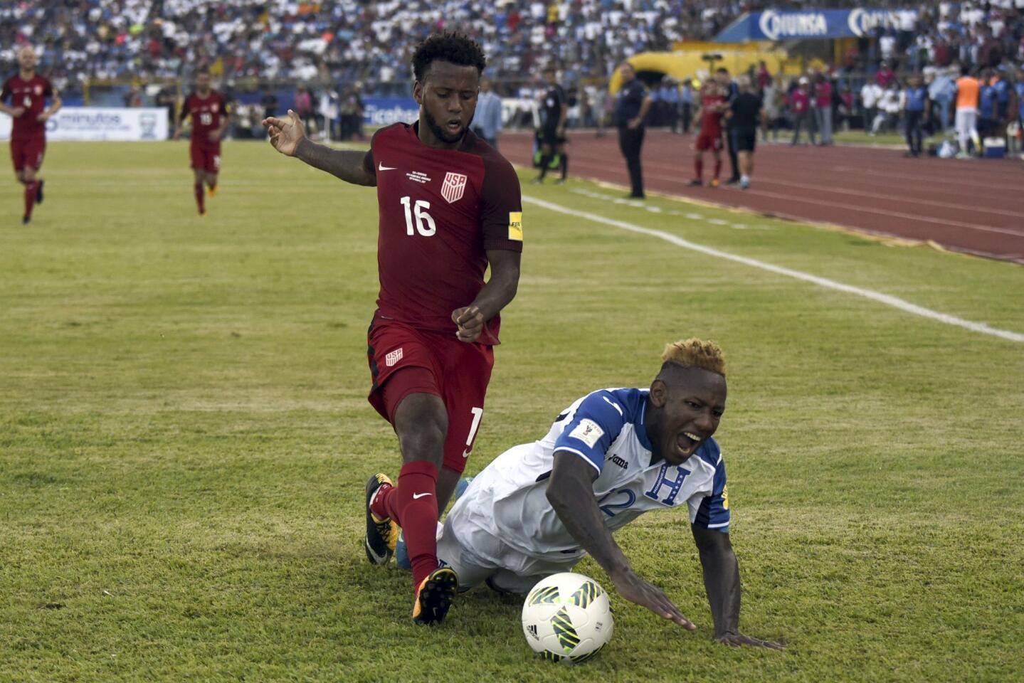 Honduras' Romell Quioto (R) falls next to USA's Kellyn Acosta during their 2018 World Cup qualifier football match in San Pedro Sula, Honduras, on September 5, 2017. / AFP PHOTO / Johan ORDONEZJOHAN ORDONEZ/AFP/Getty Images ** OUTS - ELSENT, FPG, CM - OUTS * NM, PH, VA if sourced by CT, LA or MoD **