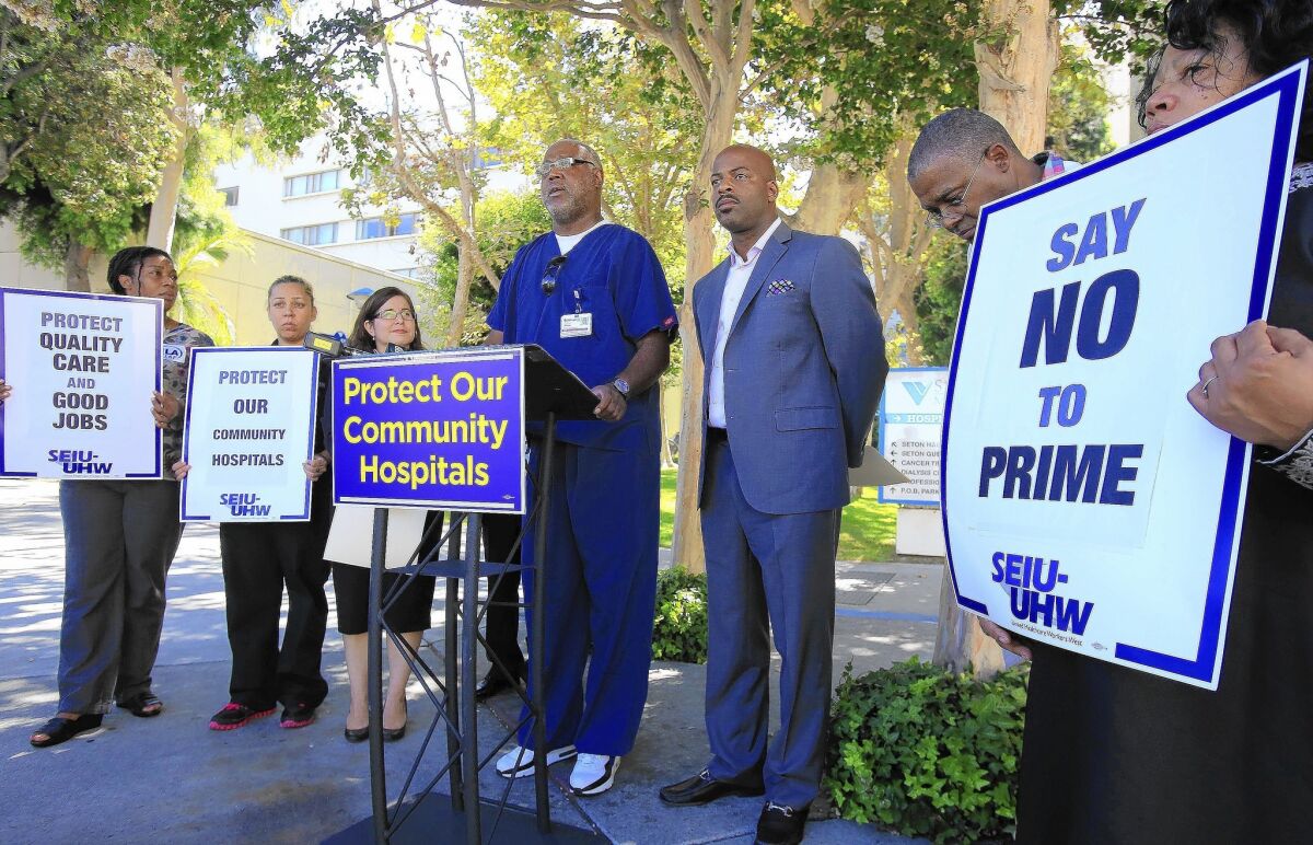 Hospital workers and union organizers hold a news conference at St. Vincent Medical Center in Los Angeles during a protest of the possible acquisition of six California hospitals to Prime Healthcare Services Inc.