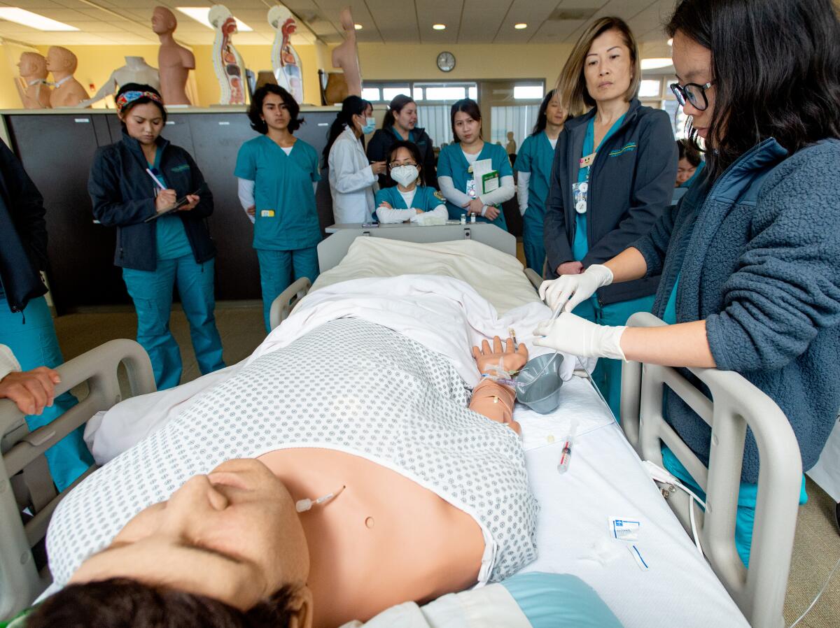 Second-year nursing students practice treatments on a dummy at Golden West College.