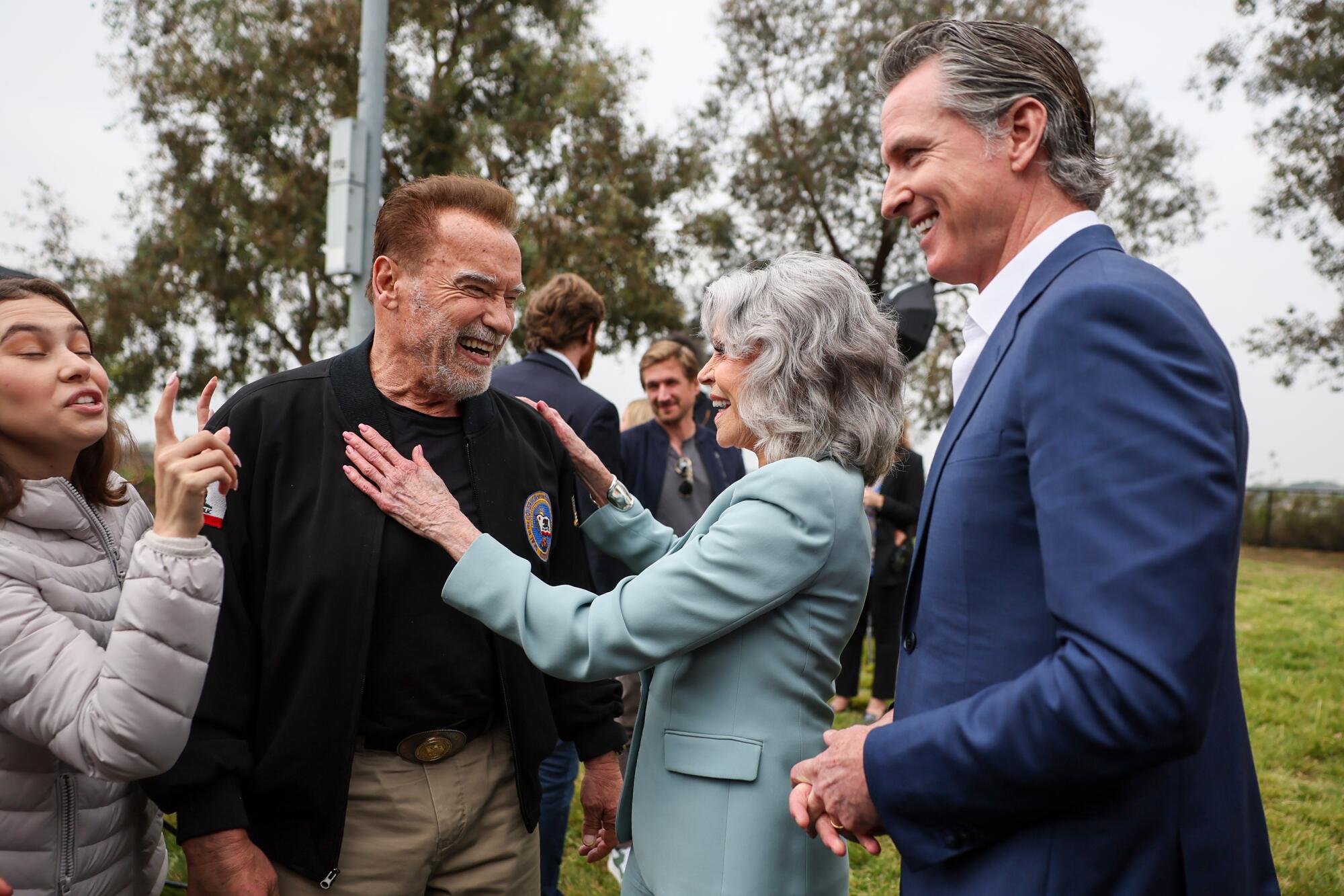 Activist Nalleli Cobo, Arnold Schwarzenegger, Jane Fonda and Gov. Gavin Newsom stand together.