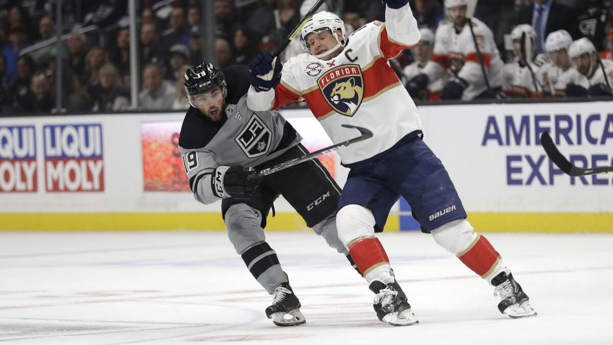 Florida Panthers captain Aleksander Barkov, right, and Kings forward Alex Iafallo chase after the puck during the first period of Saturday's game.