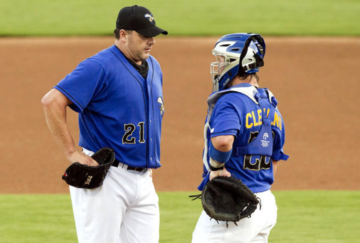 Roger Clemens talks to his son, Koby, who was his catcher during his latest outing with the Sugar Land Skeeters.