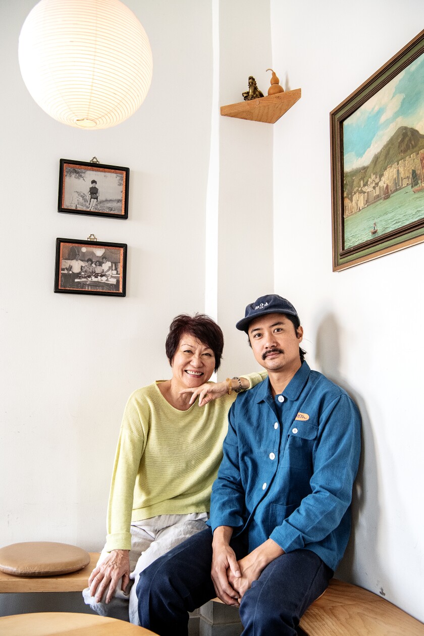 A mother and her son pose for a photograph