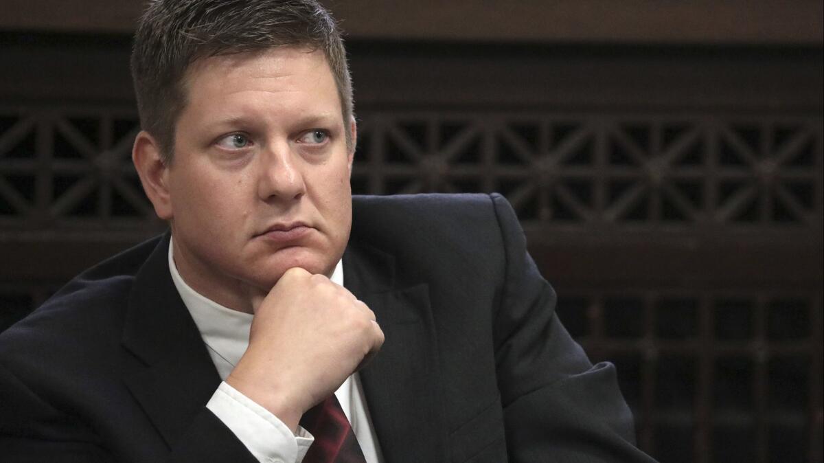 Chicago Police Officer Jason Van Dyke, charged with murder in the shooting of black teenager Laquan McDonald in 2014, listens during a hearing in September 2018.