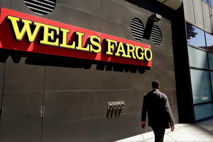 FILE - In this July 14, 2014 file photo, a man passes by a Wells Fargo bank office in Oakland, Calif. Lawyers suing Wells Fargo on behalf of aggrieved customers say in court filing late Thursday, May 11, 2017, the bank may have opened about 3.5 million unauthorized accounts, far more than the figure bank and regulators disclosed last year. (AP Photo/Ben Margot, File)