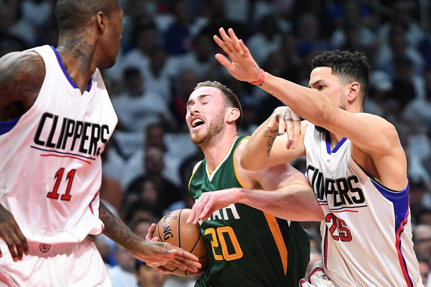 Gordon Hayward of the Jazz drives to the basketb between Clippers guards Jamal Crawford, left, and Austin Rivers during the first quarter of Game 5 of their first-round playoff series on April 25.