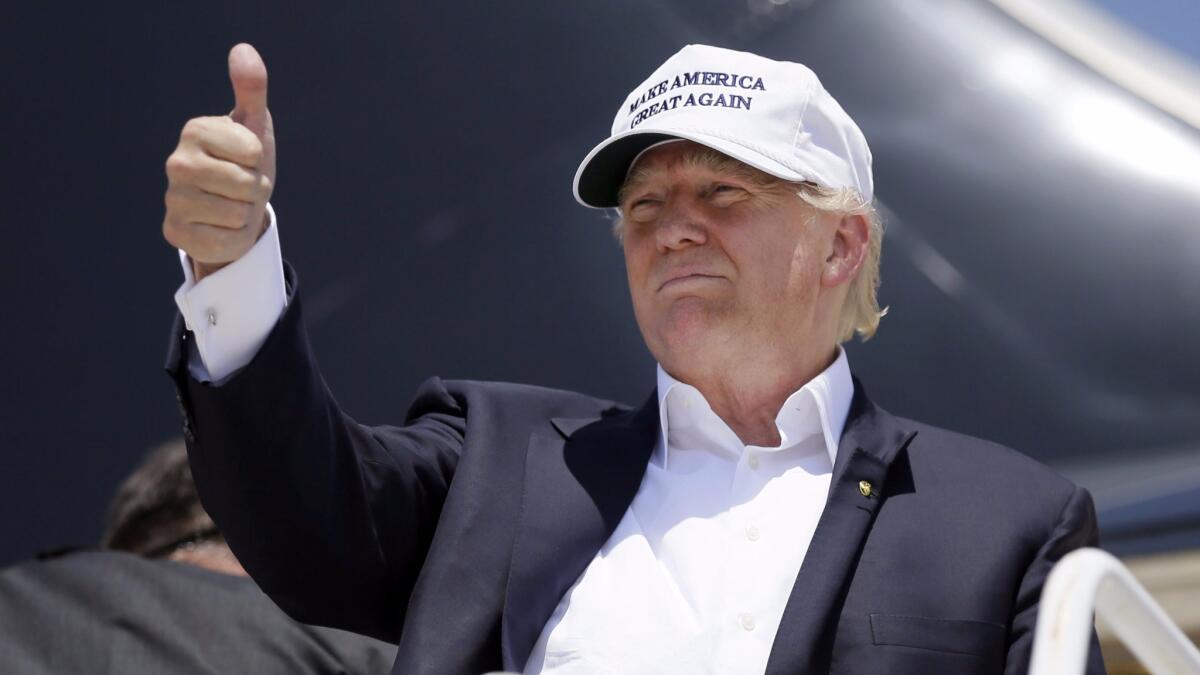 Donald Trump boards his campaign plane in Laredo, Tex., in July 2015, marking the debut of his campaign hat.