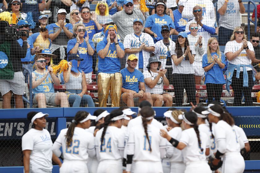 UCLA fans cheer on their team against Texas during the first inning of a Women's College World Series game June 2