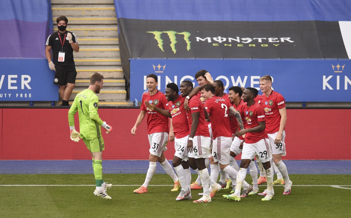 Manchester United's Jesse Lindgard celebrates with teammates after scoring his side's second goal during the English Premier League soccer match between Leicester City and Manchester United at the King Power Stadium, in Leicester, England, Sunday, July 26, 2020. (Oli Scarff/Pool via AP)