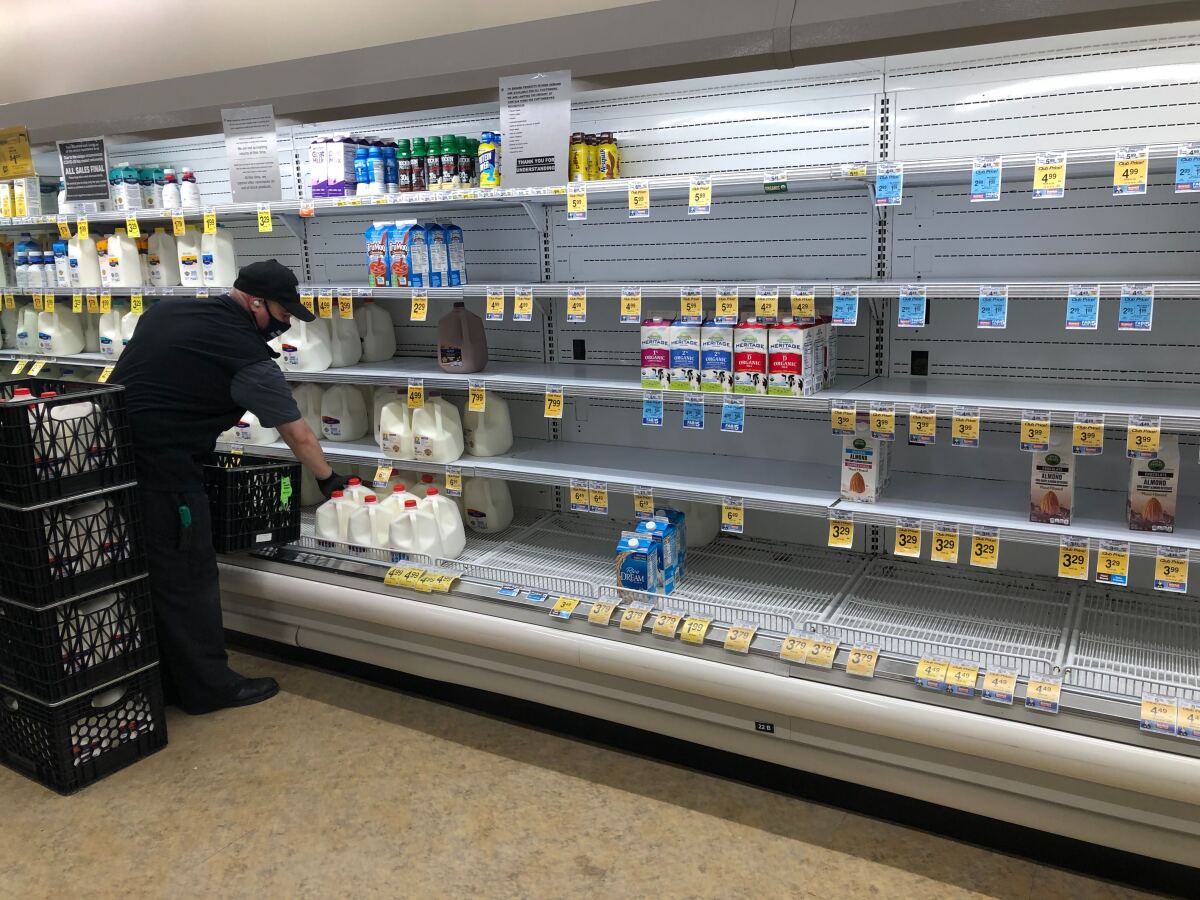 Shelves selling milk and milk alternatives are nearly empty at a Vons in Los Feliz on April 7. Signs around the store announce purchase limits and social distancing guidelines.
