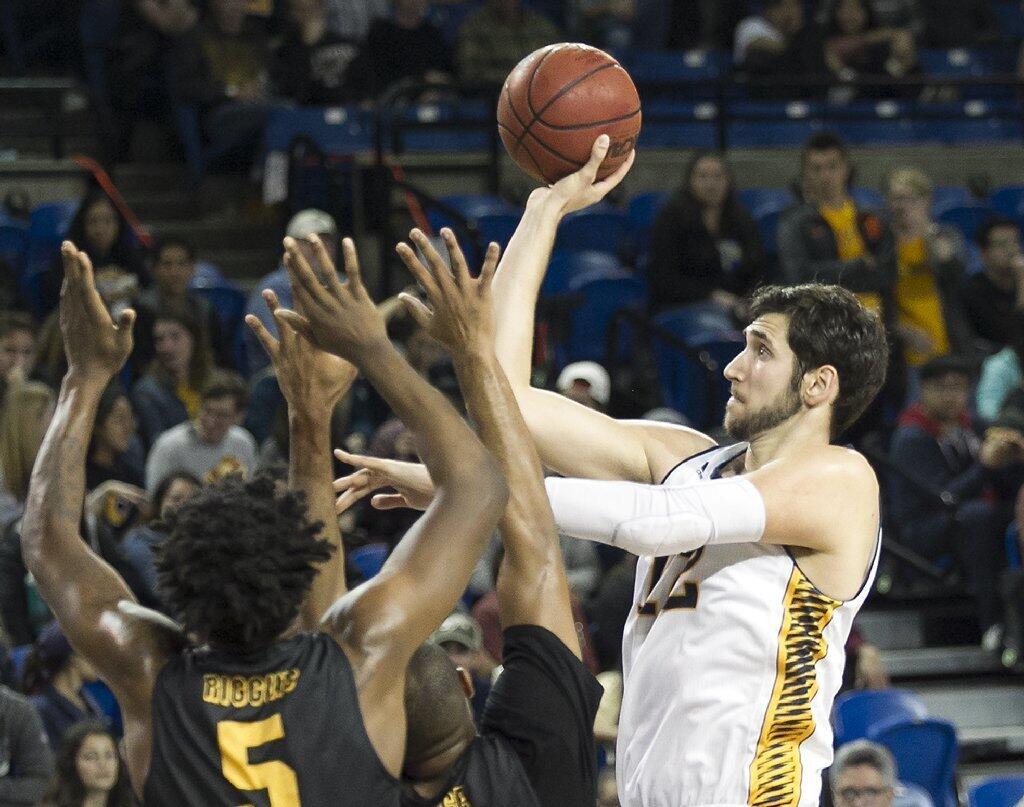 UC Irvine's Ioannis Dimakopoulos shoots and scores over Long Beach State's Mason Riggins.