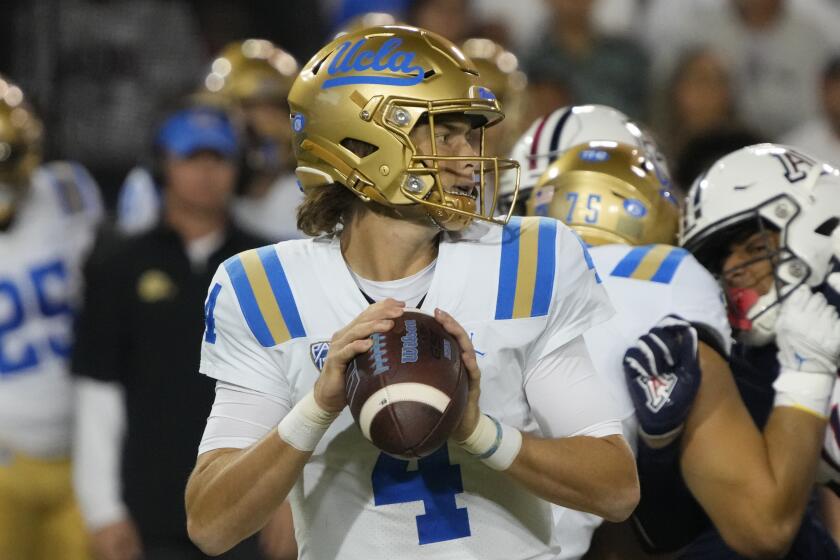 UCLA quarterback Ethan Garbers looks for a receiver during the first half.