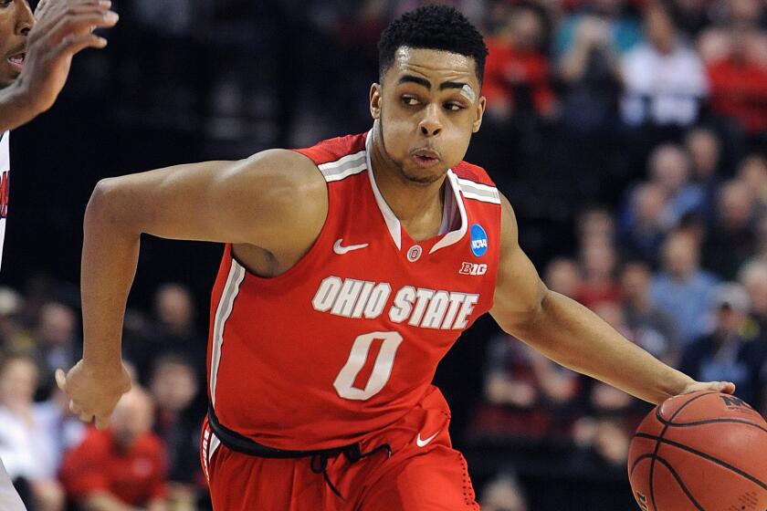 Ohio State point guard D'Angelo Russell drives to the basket during a loss to Arizona in the NCAA tournament on March 21, 2015. Russell is considered one of the top point guards available in this year's NBA draft.