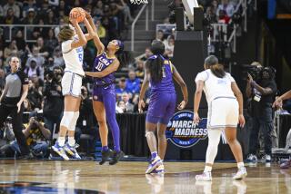 UCLA center Lauren Betts' shot is blocked by LSU forward Angel Reese during a Sweet 16 game in Albany, N.Y., on March 30