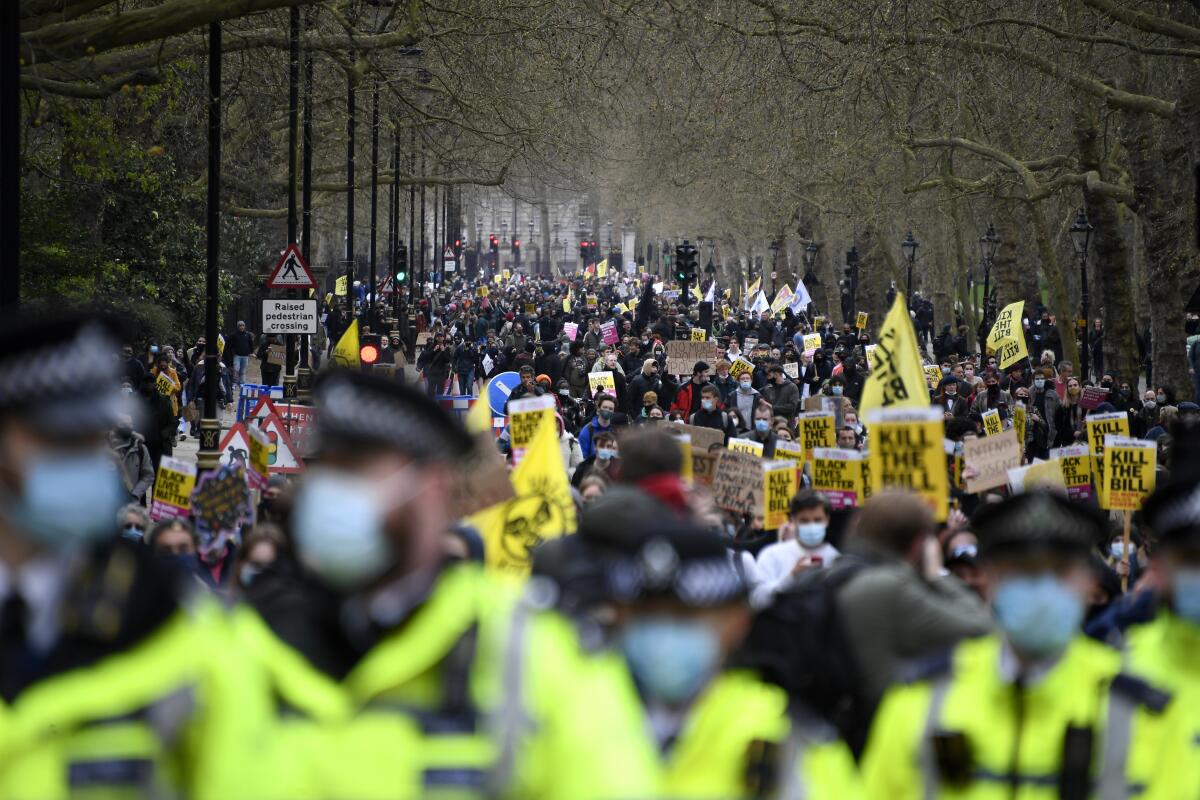 Demonstrators hold banners and flags during a 'Kill the Bill' protest in London, Saturday, April 3, 2021. The demonstration is against the contentious Police, Crime, Sentencing and Courts Bill, which is currently going through Parliament and would give police stronger powers to restrict protests. (AP Photo/Alberto Pezzali)