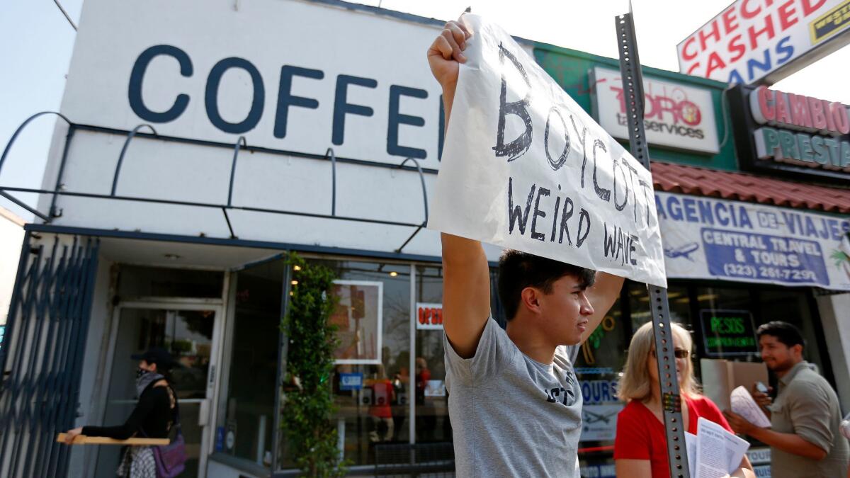 Leonardo Vilchis, 20, of Boyle Heights, along with other community members demonstrate along East Cesar E. Chavez Avenue boycotting Weird Wave Coffee Brewers.