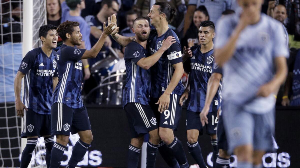 Galaxy forward Zlatan Ibrahimovic (9) celebrates with teammates after scoring a goal during the second half against Sporting Kansas City on Wednesday in Kansas City, Kan. Galaxy won 2-0.