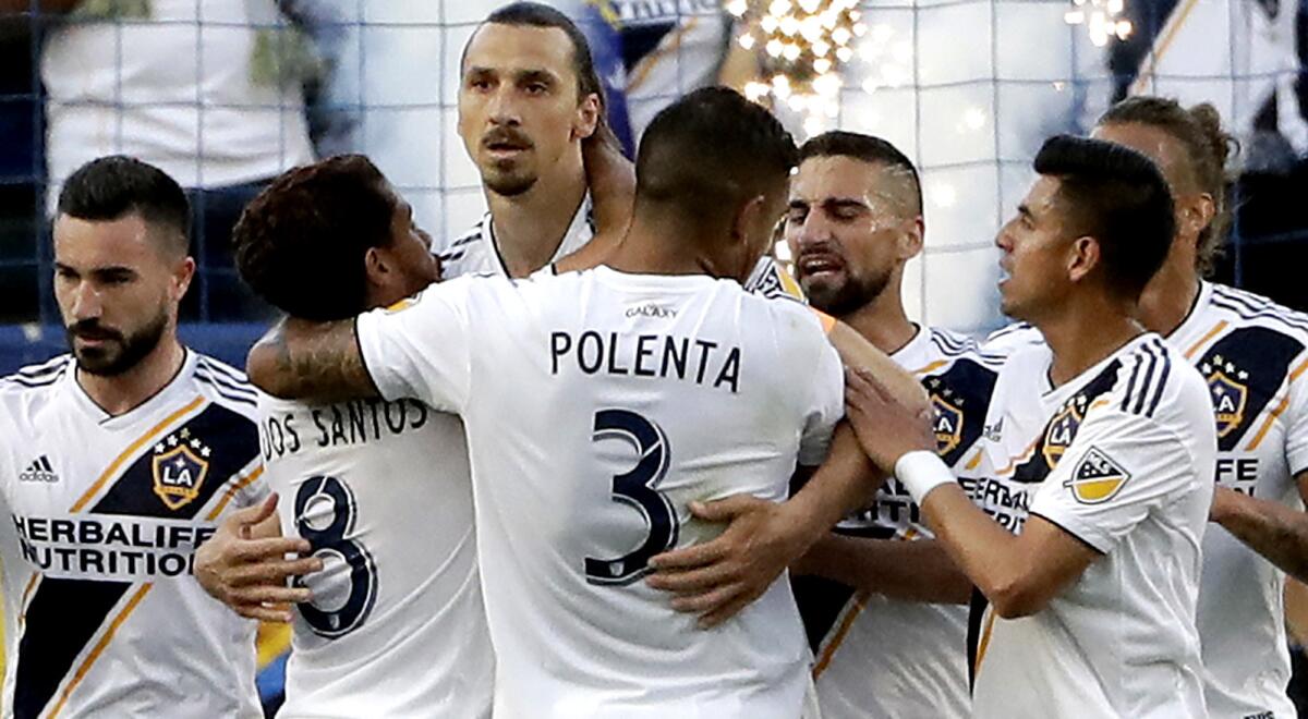 Galaxy forward Zlatan Ibrahimovic, center, is congratulated by teammates after scoring against the Timbers during the first half Sunday.