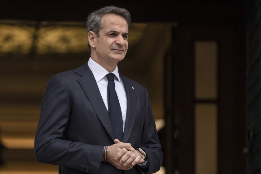 FILE - Greek Prime Ministers Kyriakos Mitsotakis looks on as he waits for the arrival of Cyprus' new President Nikos Christodoulides before their meeting in Athens, on March 13, 2023. Prime Minister Mitsotakis late Tuesday, March 22, said he would hold elections in May ‒ a month later than initially expected ‒ but did not give an exact date. (AP Photo/Petros Giannakouris, File)