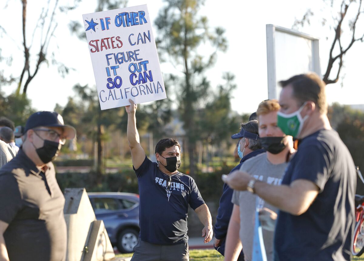 Parents and student-athletes participate in the statewide "Let Them Play" rally at Corona del Mar High on Friday.