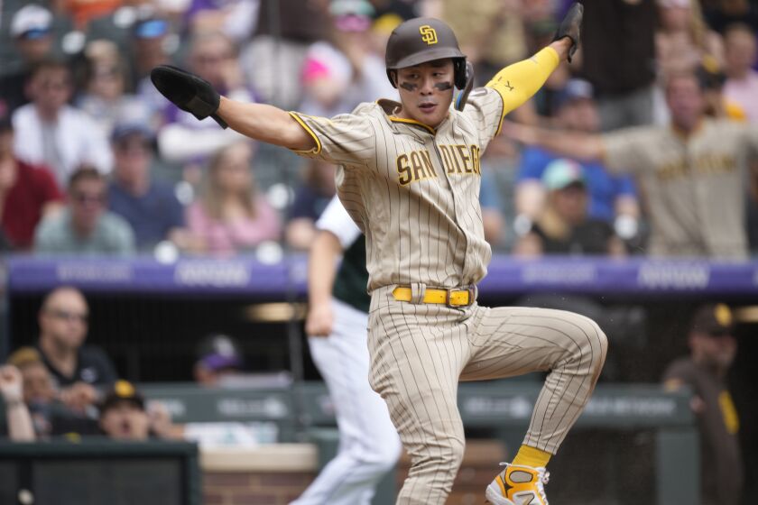 San Diego Padres' Ha-Seong Kim reacts after scoring on a single hit by Fernando Tatis Jr. off Colorado Rockies relief pitcher Jake Bird in the the sixth inning of a baseball game Saturday, June 10, 2023, in Denver. (AP Photo/David Zalubowski)