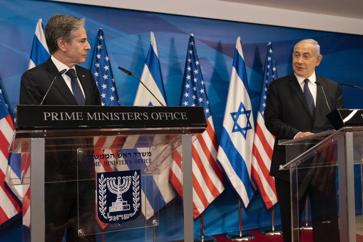 Secretary of State Antony Blinken  listens as Israeli Prime Minister Benjamin Netanyahu speaks at a news conference.