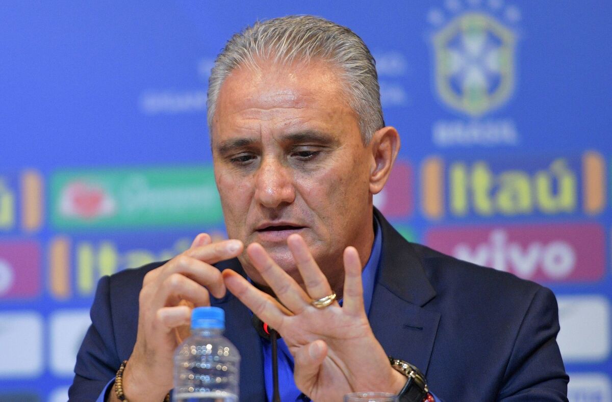Brazil's national football team coach Tite gestures as he speaks during a press conference to announce his squad of players for the upcoming friendly matches against the U.S. and El Salvador, in Rio de Janeiro on August 17, 2018. - Brazil will face the US on September 7 and El Salvador on September 11.