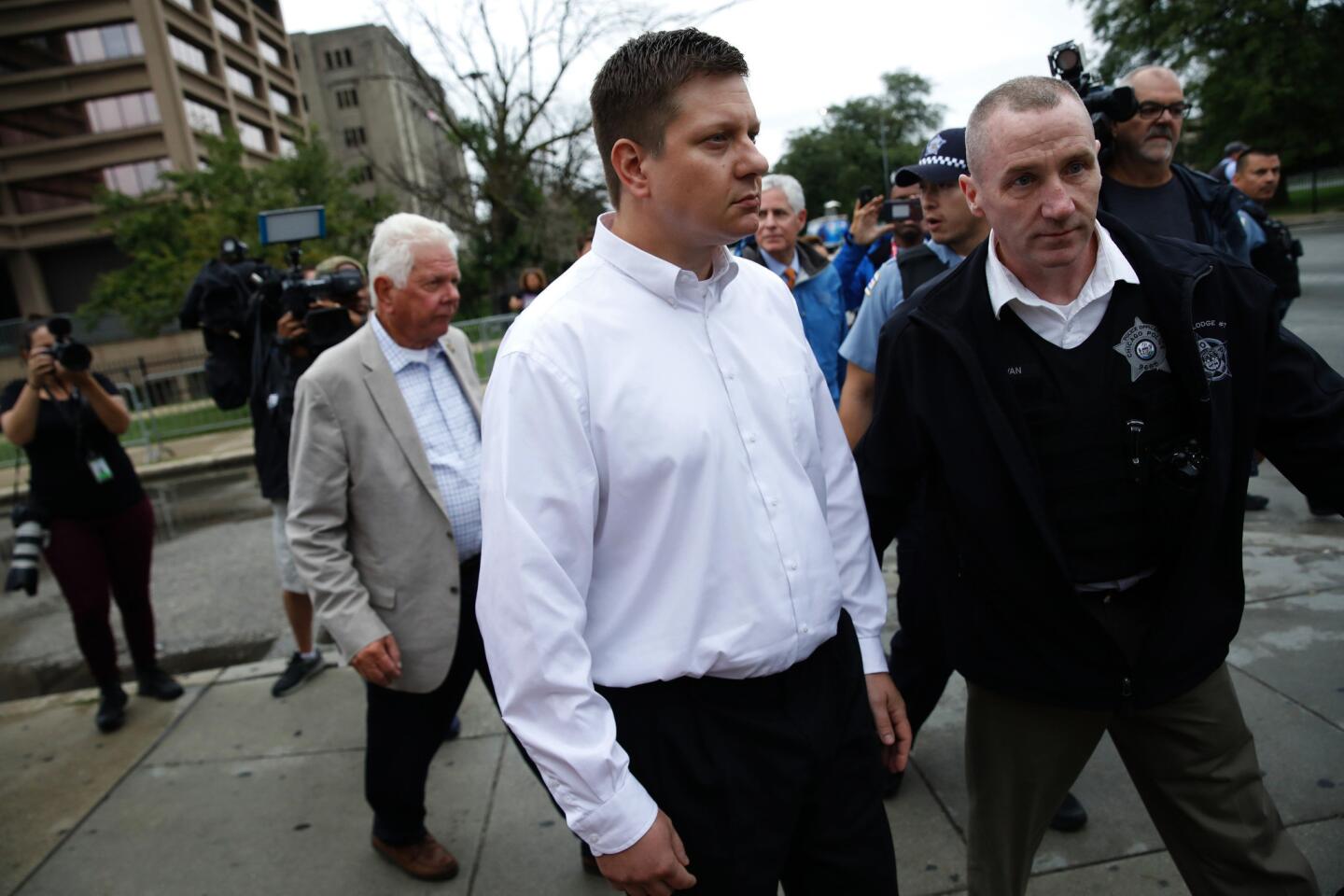 Chicago police Officer Jason Van Dyke, with father Owen at left, is escorted from Cook County Jail after posting additional bond on Sept. 6, 2018.