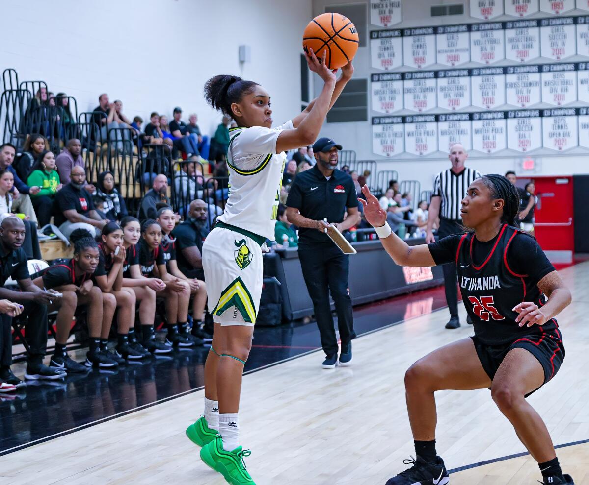 Kaleena Smith of Ontario Christian launches a shot in front of Etiwanda's Aliyahna Morris.