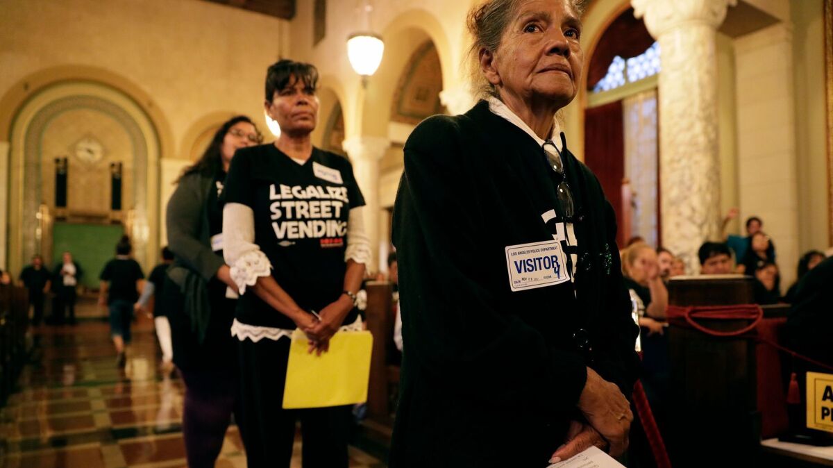 Sidewalk vendor Natalia Vasquez carries her speech while waiting to speak in favor of legalizing street vending at a hearing at Los Angeles City Hall.
