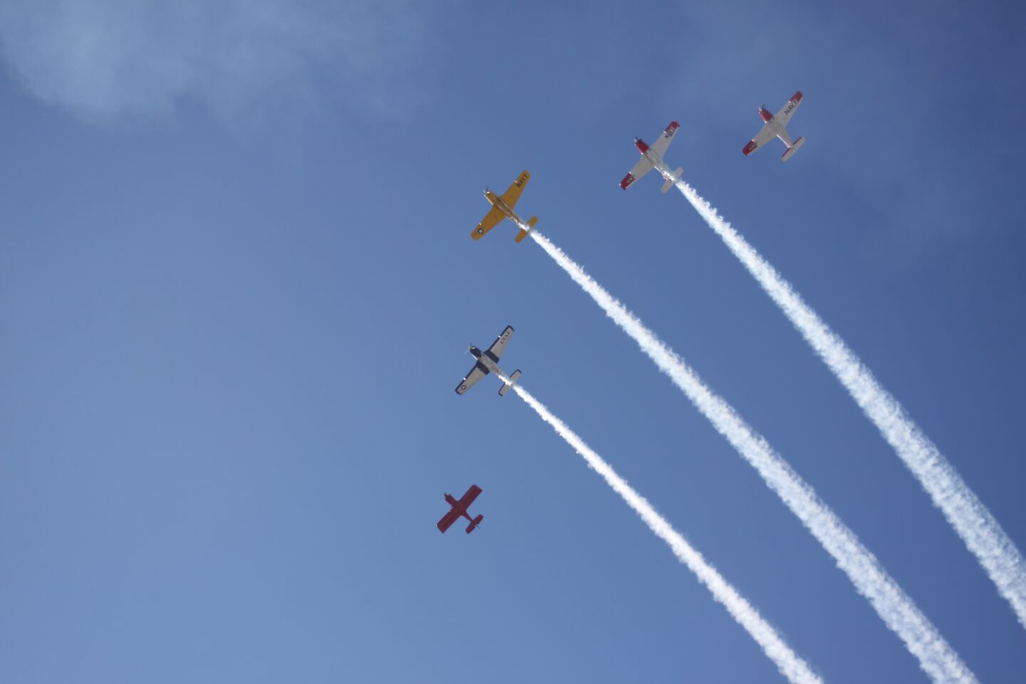 Antique airplanes fly over the La Jolla Christmas Parade to signal its start.